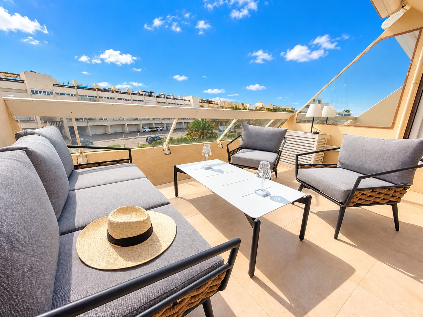 Grande terrasse avec salon de jardin et chapeau de paille